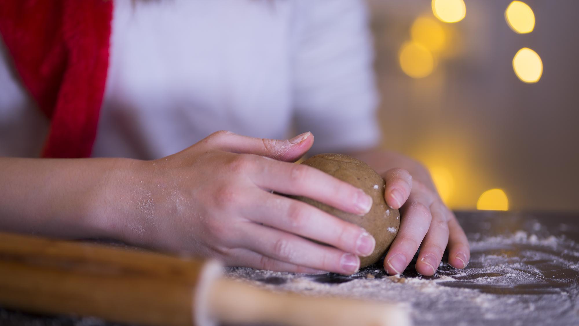 Close-up of hands kneading dough